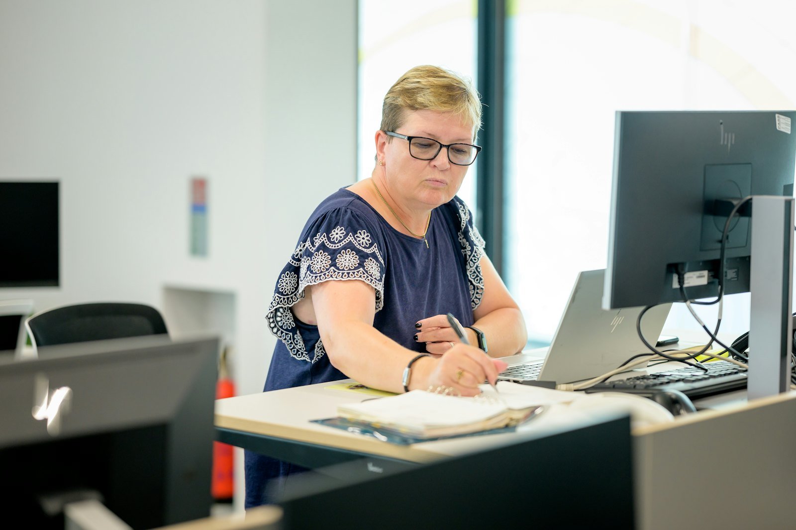 An advisor reviewing a client's financial figures at a desk